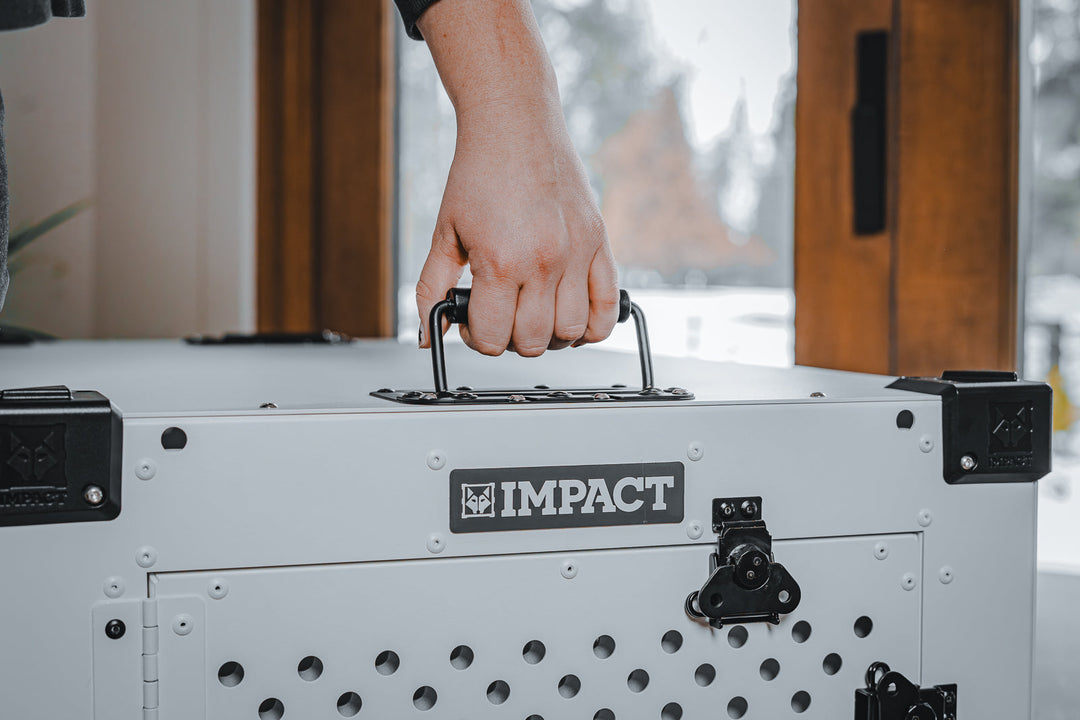 photo of a hand gripping the military grade handles on the high anxiety dog crate