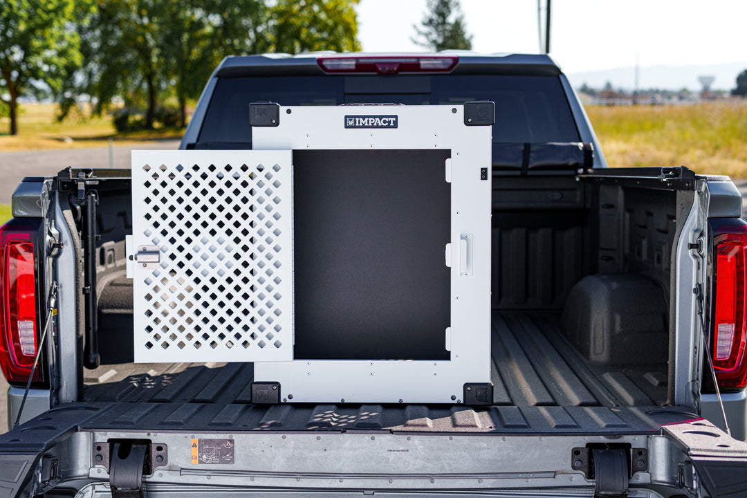puppy divider in a white collapsible crate in the back of a truck