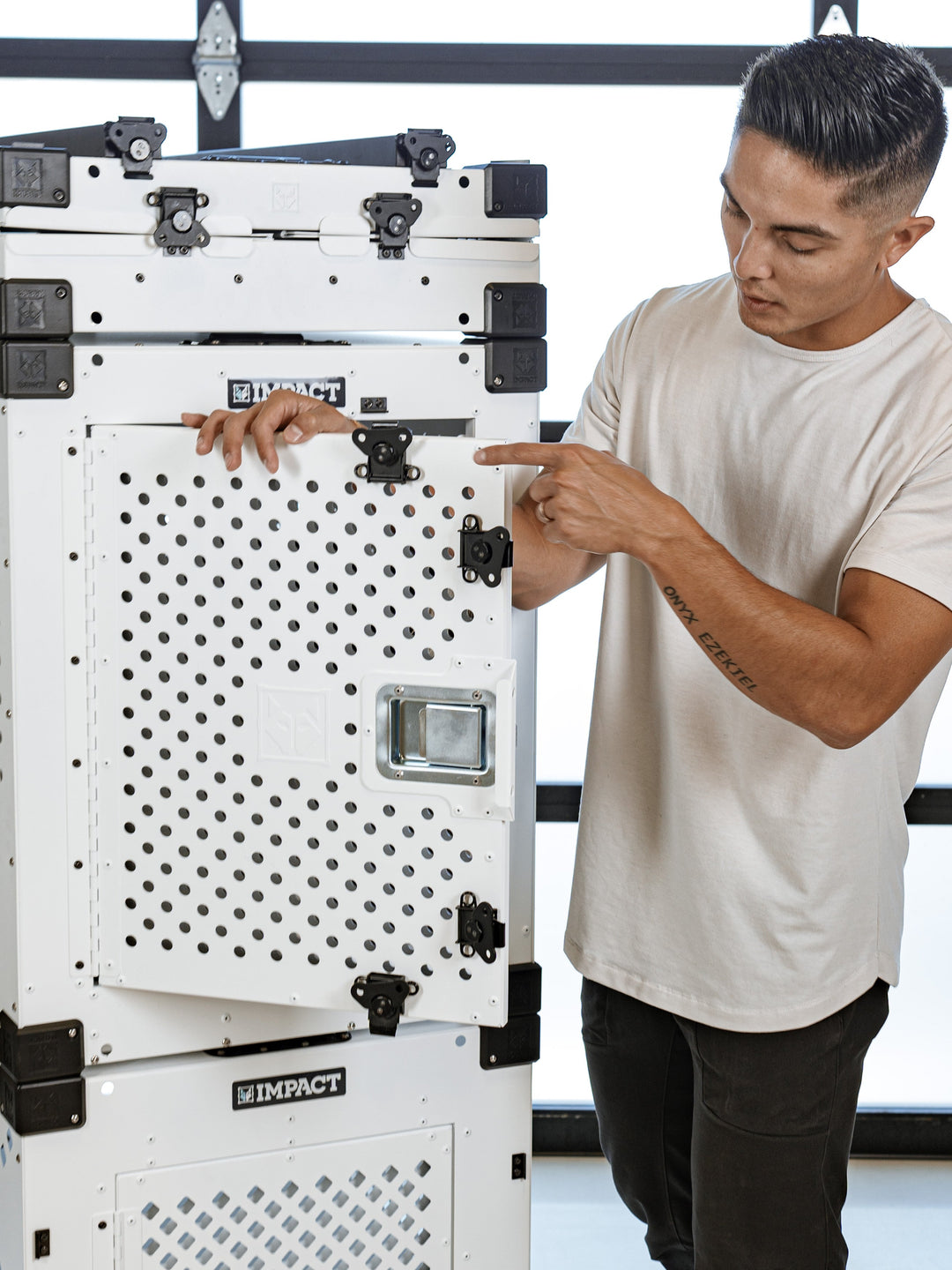 man demonstrating the functionality of the white high anxiety crate